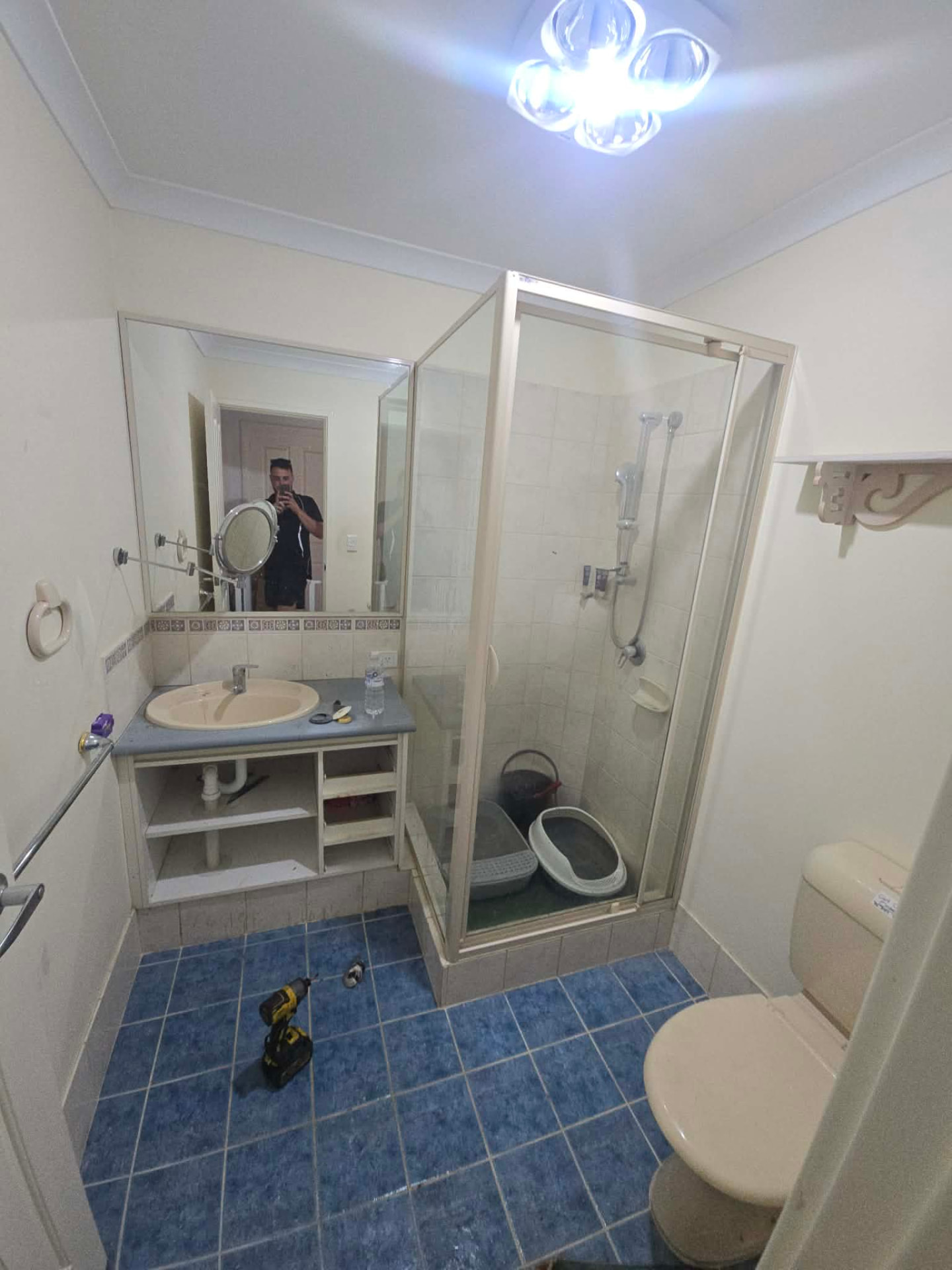 Dated Canning Vale bathroom with blue floor tiles and old vanity before renovation