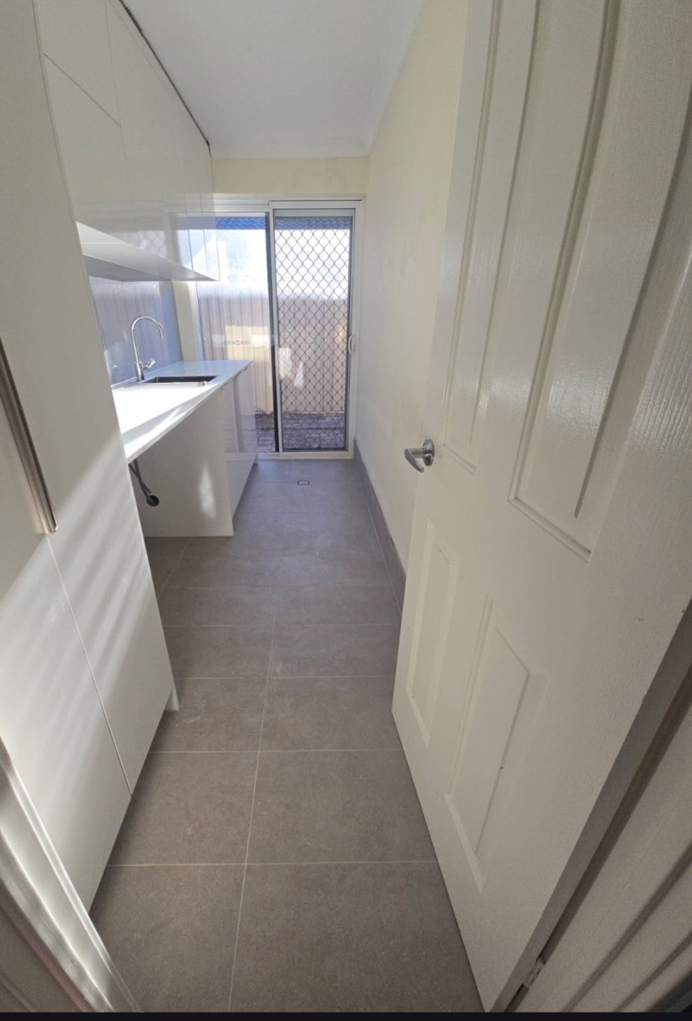 Completed laundry renovation with new cabinetry and plumbing by Luxe Flow Plumbing